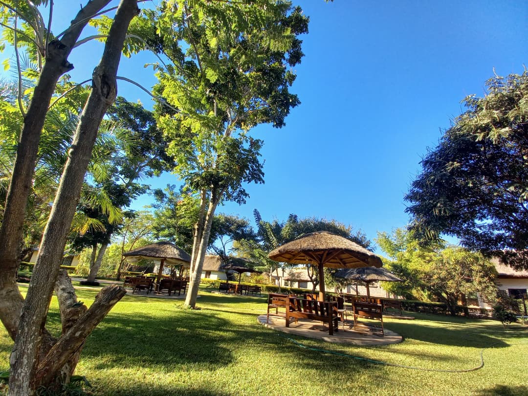 Shaded garden gazebos across the landscaped grounds at Kumudzi Innovation Centre
